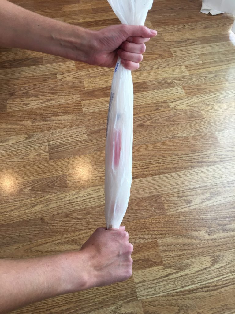 Straighten and tighten plastic bag for putting on compression sock