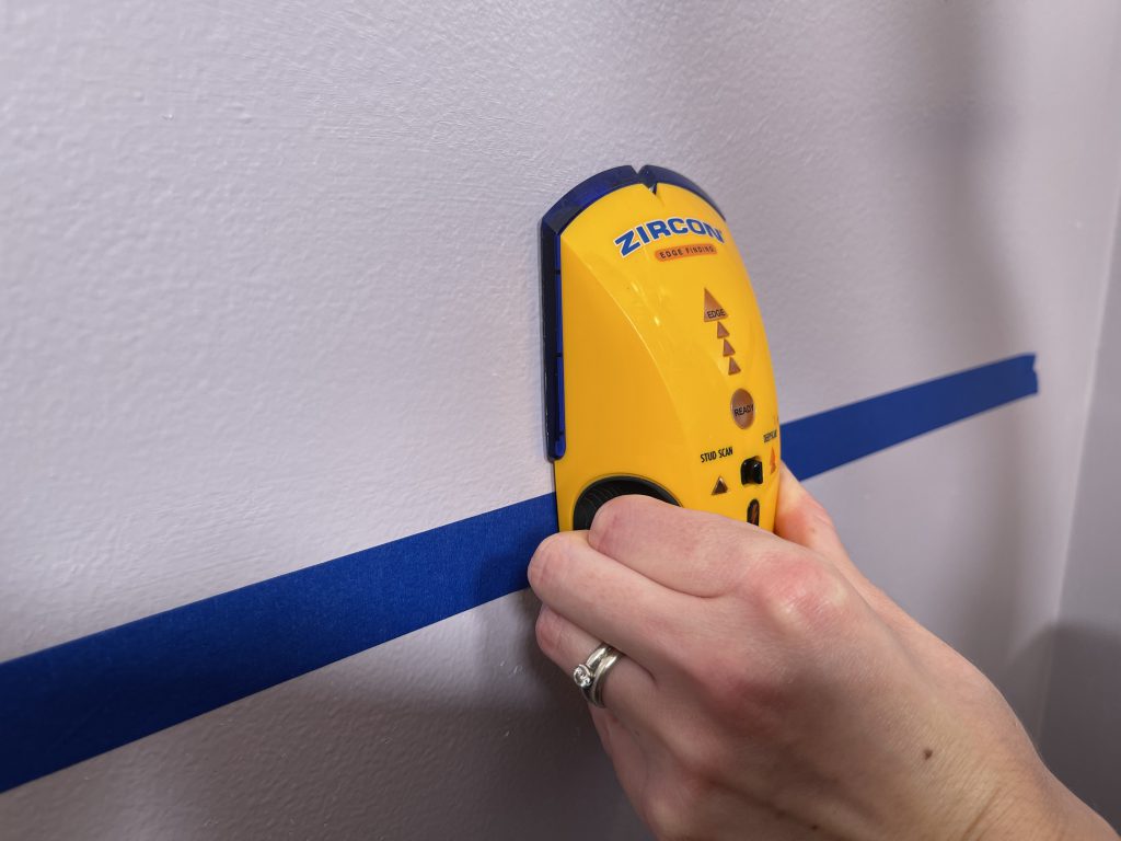 Stud finder scanning for stud in wall - how to install a grab bar