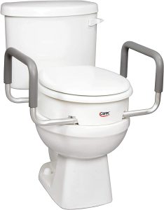 Looking at the front of a toilet, a bolt-on toilet seat riser is installed. The toilet seat has been removed.