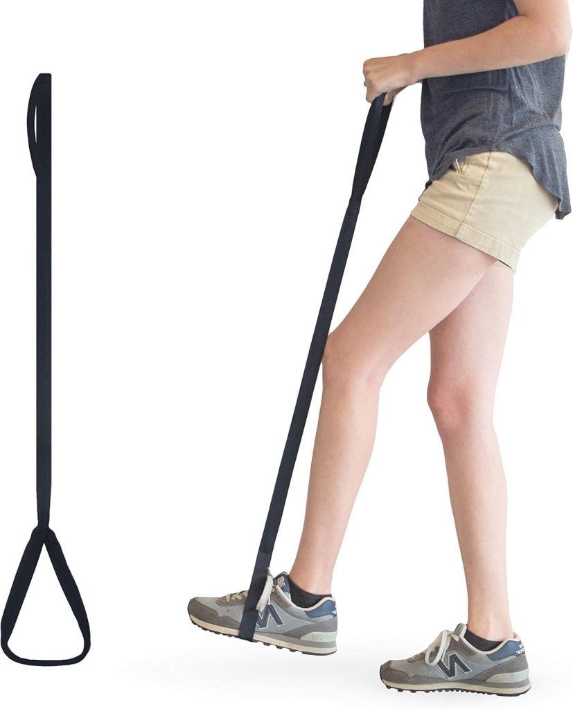 A leg lifter strap in use, with a person demonstrating how to lift their leg using the sturdy nylon loop. The individual is wearing a dark gray shirt, beige shorts, and gray sneakers. The strap features a large foot loop at the bottom and a hand loop at the top for easy grip, designed to assist individuals with limited mobility in moving their legs. A standalone view of the leg lifter strap is also shown to the left. How to Get In and Out of the Car After Hip Replacement